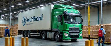 Large SwiftTrack freight lorry loading parcels at a distribution centre